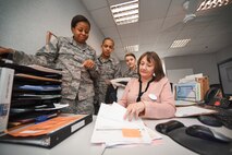 U.S. Airmen from the 100th Force Support Squadron receive training from Jennifer Munns, 100th FSS Force Management military personnel clerk, at RAF Mildenhall, England, April 17, 2018. Military personnel flight Airmen are the heart of the mission, ensuring Airmen and their families are cared for when they arrive and leave the base. (U.S. Air Force photo by Senior Airman Christine Groening)