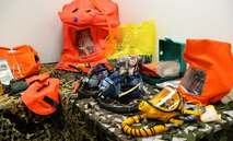 The 100th Operations Support Squadron aircrew flight equipment shop displays oxygen and chemical gear at RAF Mildenhall, England, April 24, 2018. Emergency kits are packed on every plane for crew and passengers. The kits hold a variety of equipment, including 80 four-ounce packets of water, a compass, lights and a radio kit. The aircrew flight equipment technicians ensure all RAF Mildenhall’s aircrew are ready and prepared for any mission, at any time. (U.S. Air Force photo by Airman 1st Class Alexandria Lee)