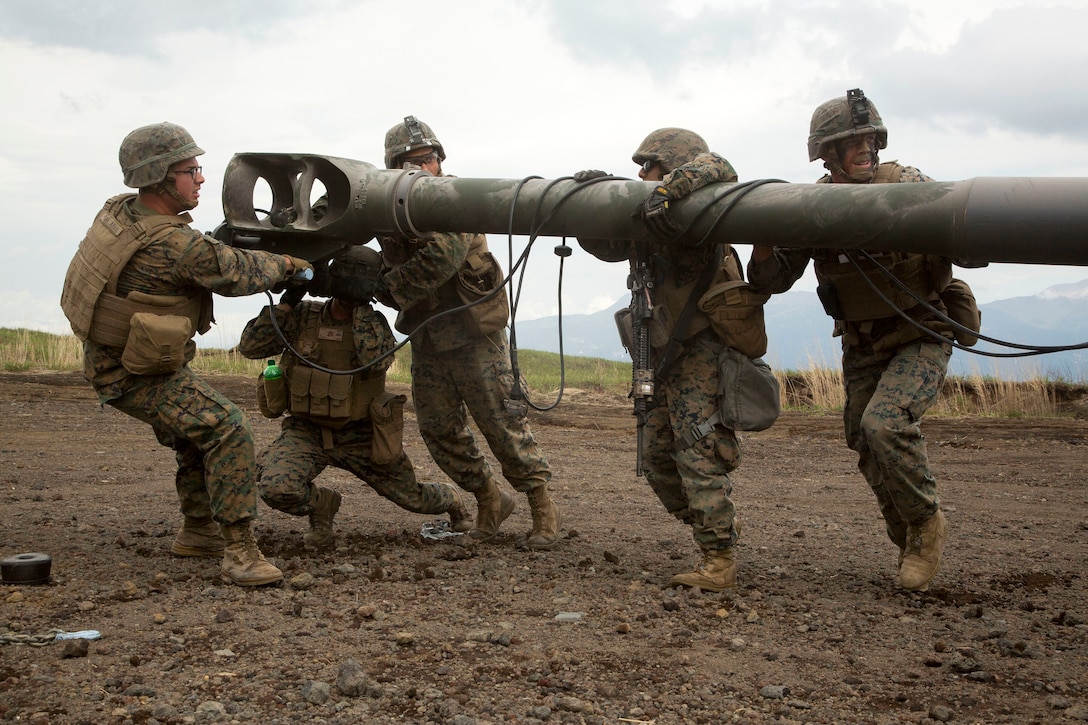 Marines position a howitzer before conducting live-fire training.