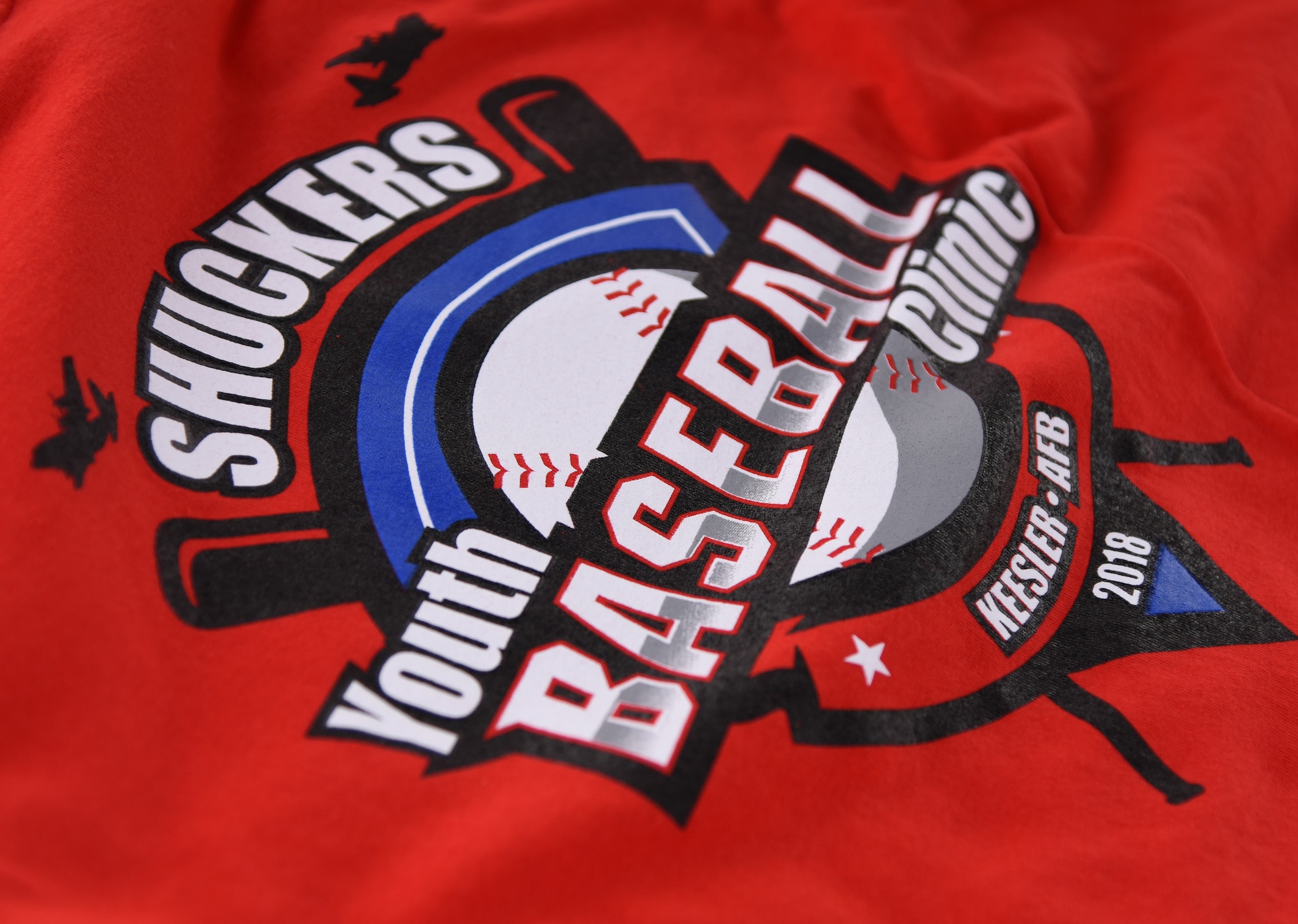 A t-shirt is on display during the Biloxi Shuckers Youth Baseball Clinic on the youth center baseball field at Keesler Air Force Base, Mississippi, May 5, 2018. More than 20 children attended the clinic that provided hitting, pitching, base running and fielding instruction from members of the Biloxi Shuckers minor league baseball team. (U.S. Air Force photo by Kemberly Groue)