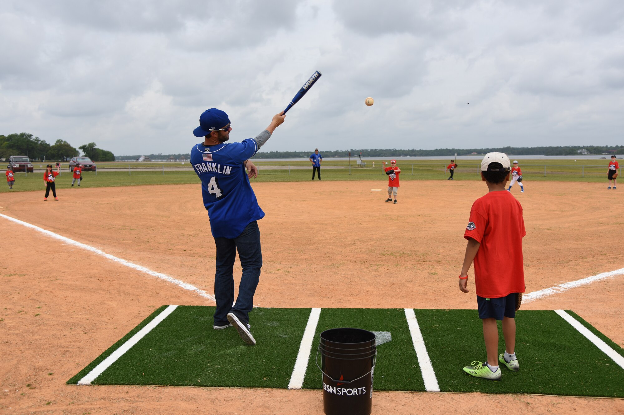 Nick Franklin, Biloxi Shuckers infielder, hits baseballs to Keesler children during the Biloxi Shuckers Youth Baseball Clinic on the youth center baseball field at Keesler Air Force Base, Mississippi, May 5, 2018. More than 20 children attended the clinic that provided hitting, pitching, base running and fielding instruction from members of the Biloxi Shuckers minor league baseball team. (U.S. Air Force photo by Kemberly Groue)