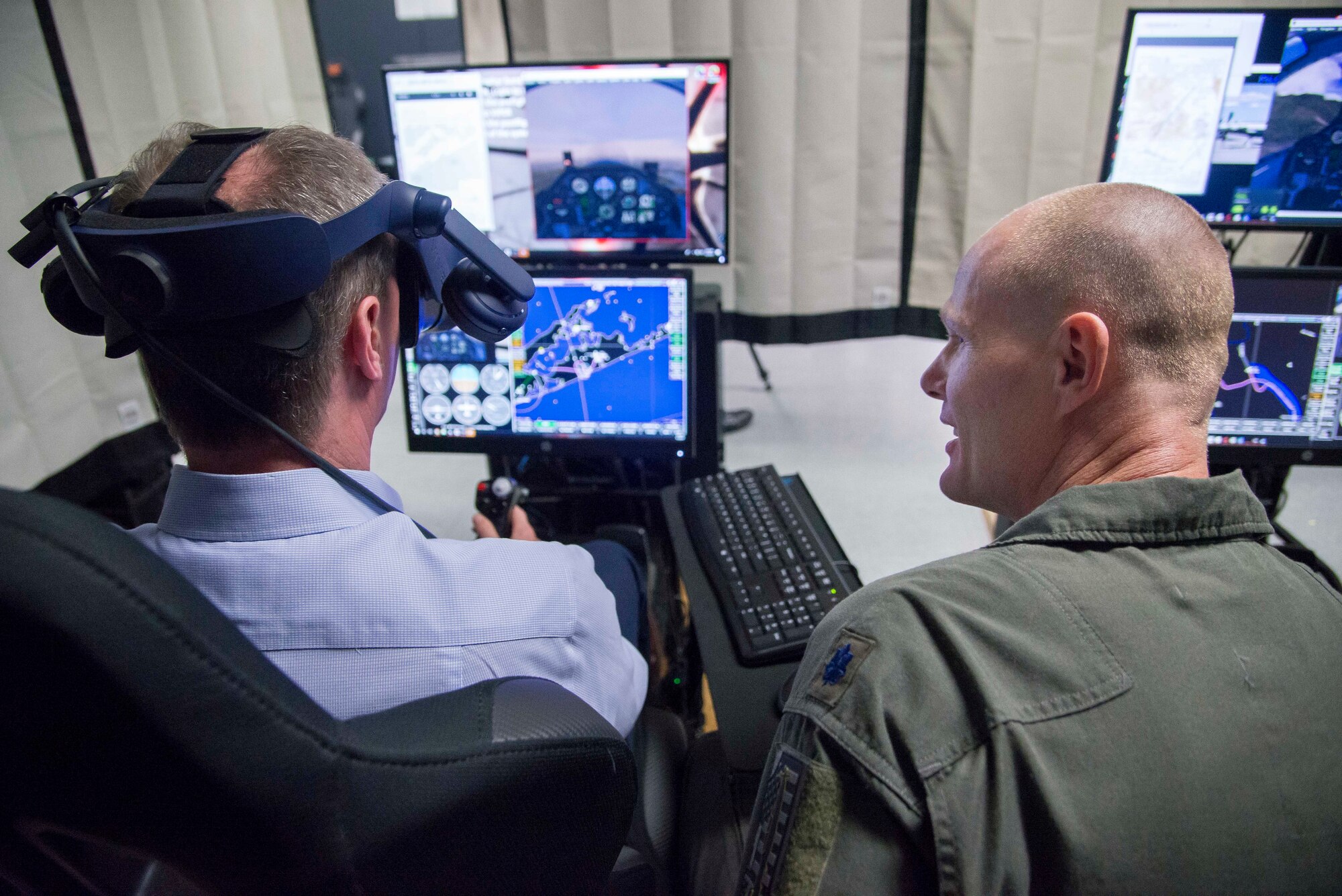 Royal Air Force Air Marshall Sean Reynolds (left), senior officer responsible for personnel and capability of the United Kingdom’s RAF and U.S. Air Force Lt. Col. Robert Vicars, Pilot Training Next initiative director, go through a flight simulator at the Pilot Training Next detachment in Austin, Texas, May 3, 2018. Reynolds’ visit involved a tour of PTN facilities to better understand how Air Education and Training Command uses existing and emerging technologies to decrease the time and cost of training, without sacrificing depth of learning and strengthened partnerships through the sharing of best practices and mutual interests. (U.S. Air Force photo by Sean Worrell)