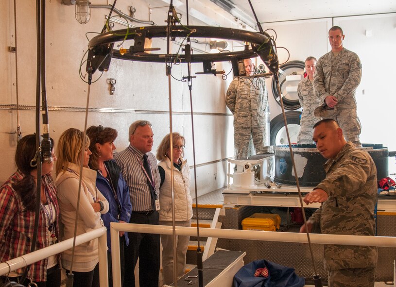 Staff Sgt. Adam Pruitt, 790th Maintenance Squadron missile maintenance technician topside instructor, shows a group of local educators the inside of a payload transport on F.E. Warren Air Force Base, Wyo., April 19, 2016. The educators teach and look after many of the children of on-base residents. (U.S. Air Force photo by Senior Airman Jason Wiese)