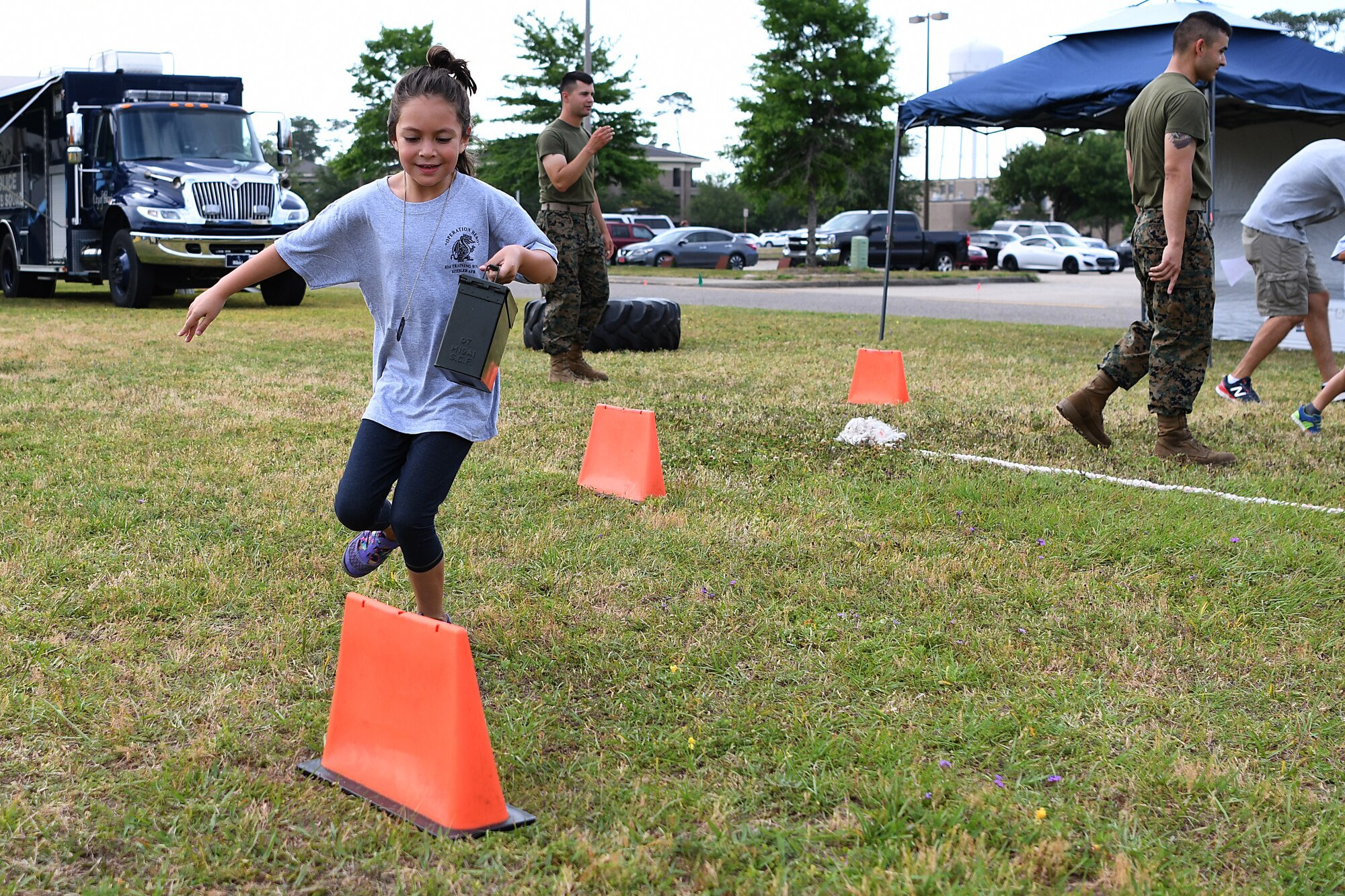 Mady Gutierrez, daughter of U.S. Air Force Master Sgt. Rogelio Gutierrez, 334th Training Squadron military training leader flight chief, participates in an obstacle course during Operation Hero  at Keesler Air Force Base, Mississippi, May 5, 2018. During the event, children had different tasks to complete before getting a tour of a C-130J Hercules. (U.S. Air Force photo by Airman 1st Class Suzie Plotnikov)