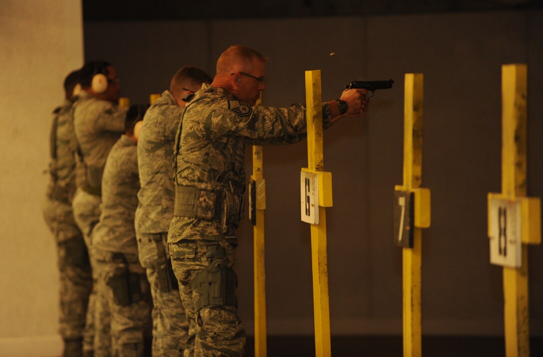 Security Forces Squadron Airmen fire off M9 pistol rounds for training at Ellsworth Air Force Base, S.D., Oct. 13, 2015. Airmen are trained on proper weapon control to ensure that personnel know how to safely and properly operate their weapon for protective uses. (U.S. Air Force photo by Airman Sadie Colbert/Released)