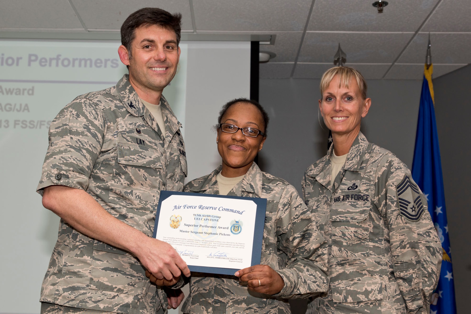 U.S. Air Force Reserve Master Sgt. Stephanie Pickens, non-commissioned officer in charge, installation personnel readiness, 913th Force Support Squadron, poses for a photo with Col. Christopher Lay, the 913th Airlift Group commander, and Chief Master Sgt. Kimberly Lord, superintendent, 913th AG, during an All Call, May 5, 2018, at Little Rock Air Force Base, Ark.