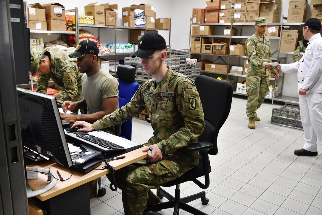 A soldier reviews the food supply inventory listing.