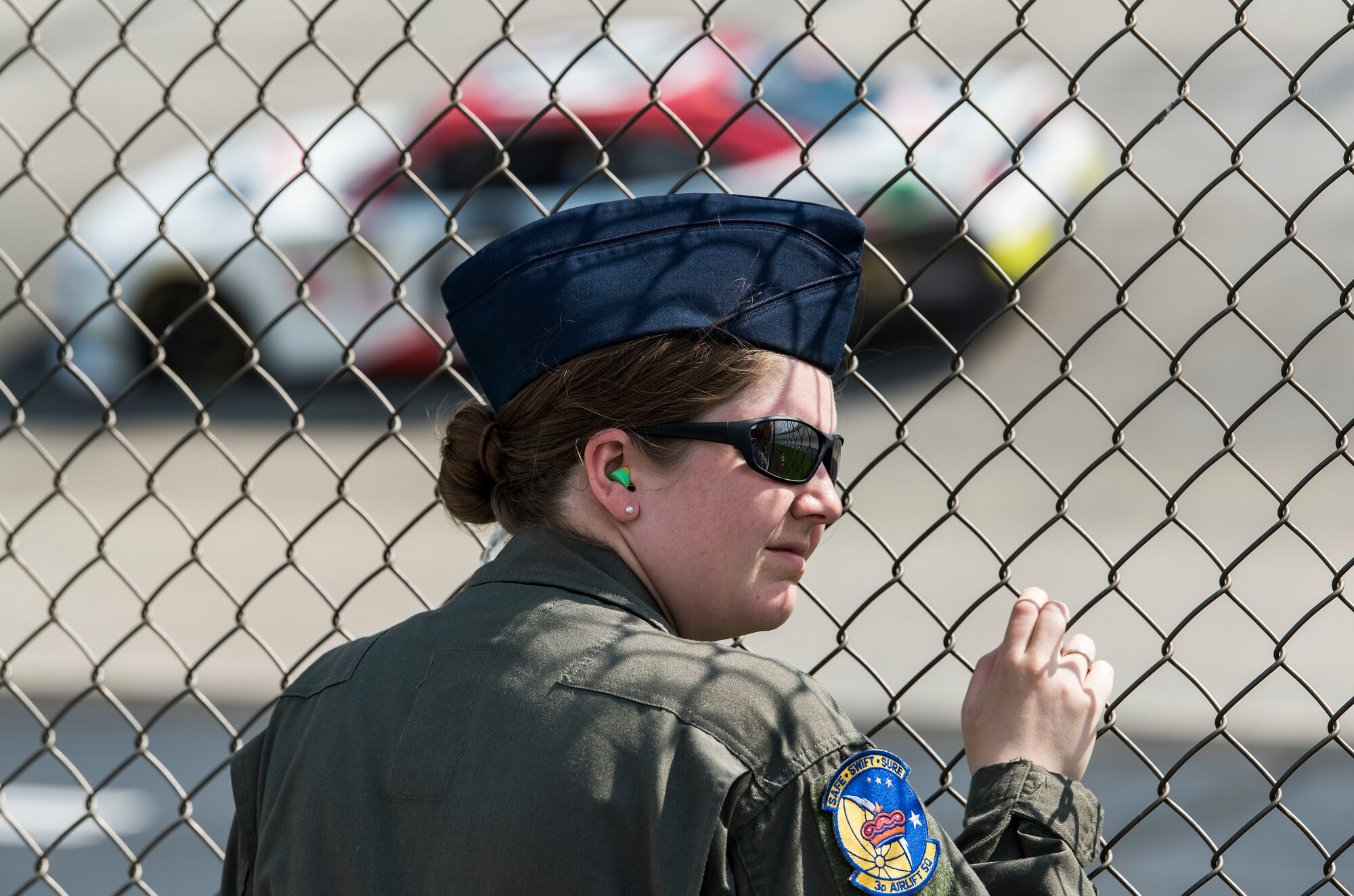 Senior Airman Ashley Jones, 3rd Airlift Squadron loadmaster, watches NASCAR XFINITY Series race cars take practice laps May 4, 2018, at Dover International Speedway, Dover, Del. Jones and other honorary pit crew members watched race cars practice for the 37th Annual “OneMain Financial 200” race scheduled for May 5. (U.S. Air Force photo by Roland Balik)