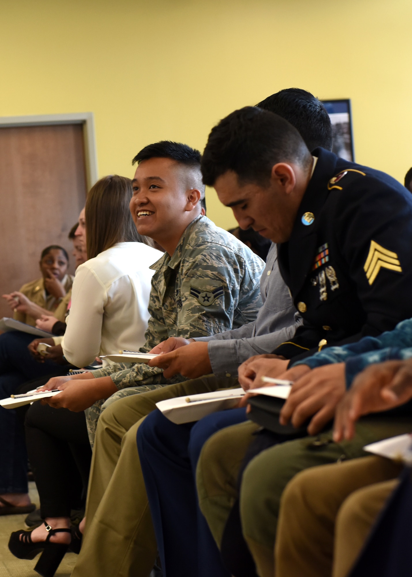 Service members in a court room wait for naturalization.