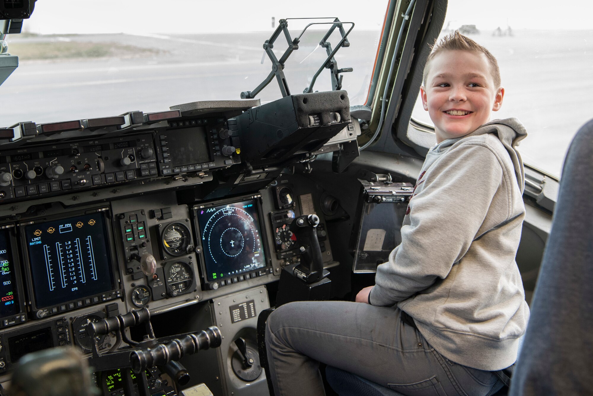 A Mountain View elementary school 5th- grade student sits in the cockpit of the C-17 Globemaster III static display at the “Day in the Life of Airmen” tour on Joint Base Elmendorf-Richardson, Alaska, May 4, 2018. The tour provided an interactive educational experience for the students while allowing service members the opportunity to serve the local community.