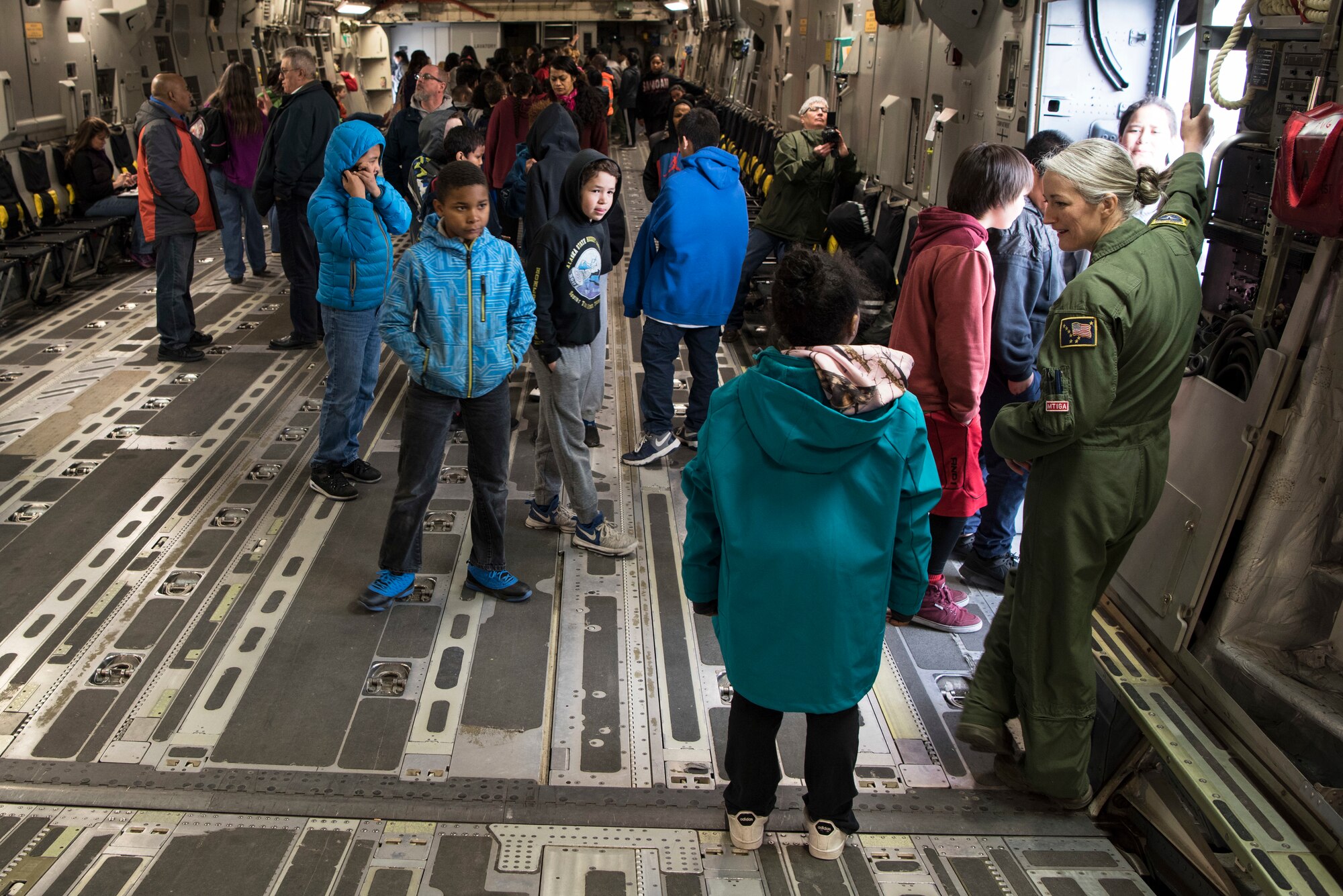 Students in 5th-grade from Wonder Park and Mountain View elementary schools interact with C-17 Globemaster III aircrew at the “Day in the Life of Airmen” tour on Joint Base Elmendorf-Richardson, Alaska, May 4, 2018. Subject-matter experts led the students through displays of a C-17 Globemaster III, F-22 Raptor, Aerospace Ground Equipment and more. The tour included a pilot, loadmaster, crew chief and several other SMEs to speak about the displays.