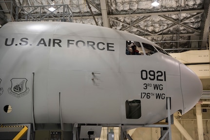 Students in 5th-grade from Wonder Park and Mountain View elementary schools peek through the window of a C-17 Globemaster III trainer at the “Day in the Life of Airmen” tour on Joint Base Elmendorf-Richardson, Alaska, May 4, 2018. The tour provided an interactive educational experience for the students while allowing service members the opportunity to serve the local community.