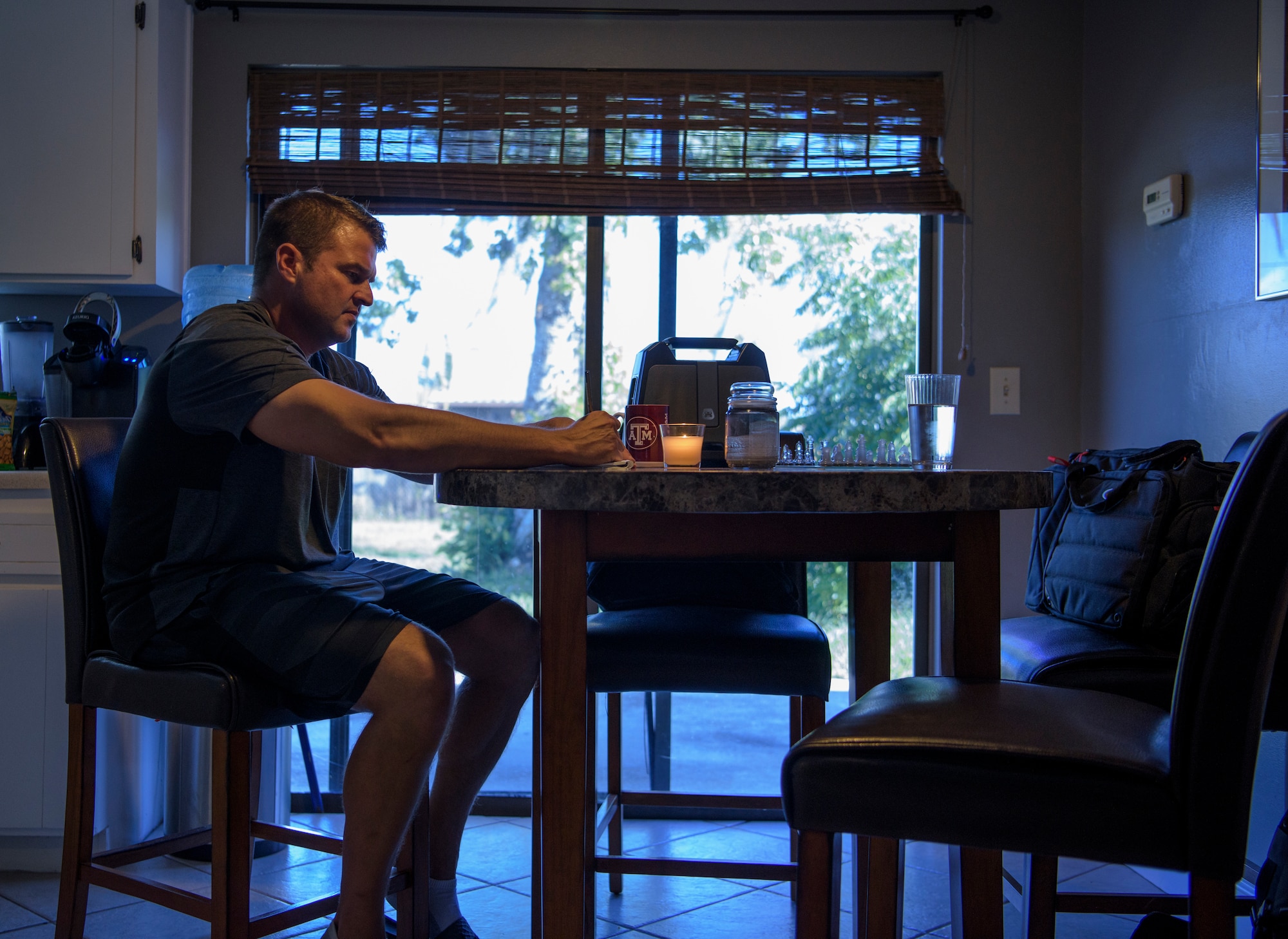 Officer Tim Bull, a Combat Arms Training and Maintenance instructor, sketches a drawing at his kitchen table after work, April 24, 2018, in Palm Bay, Fla. His wife passed away from cancer, 7 years ago. (U.S. Air Force photo by Airman 1st Class Dalton Williams)