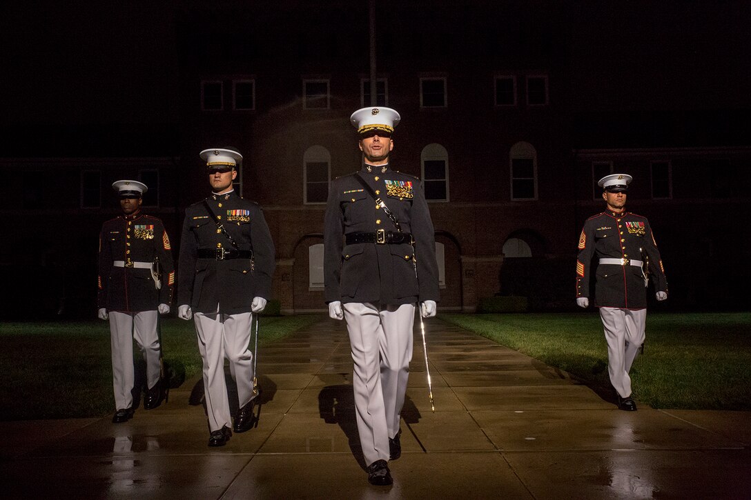 Marines with the Marine Barracks Washington D.C. parade marching staff march down Center Walk during a Friday Evening Parade, at the Barracks, May 4, 2018. The Friday Evening Parade was the first of the 2018 season. The vice president was the guest of honor, and the parade was hosted by Commandant of the Marine Corps Gen. Robert B. Neller.  (U.S. Marine Corps photo by Sgt. Robert Knapp/Released)