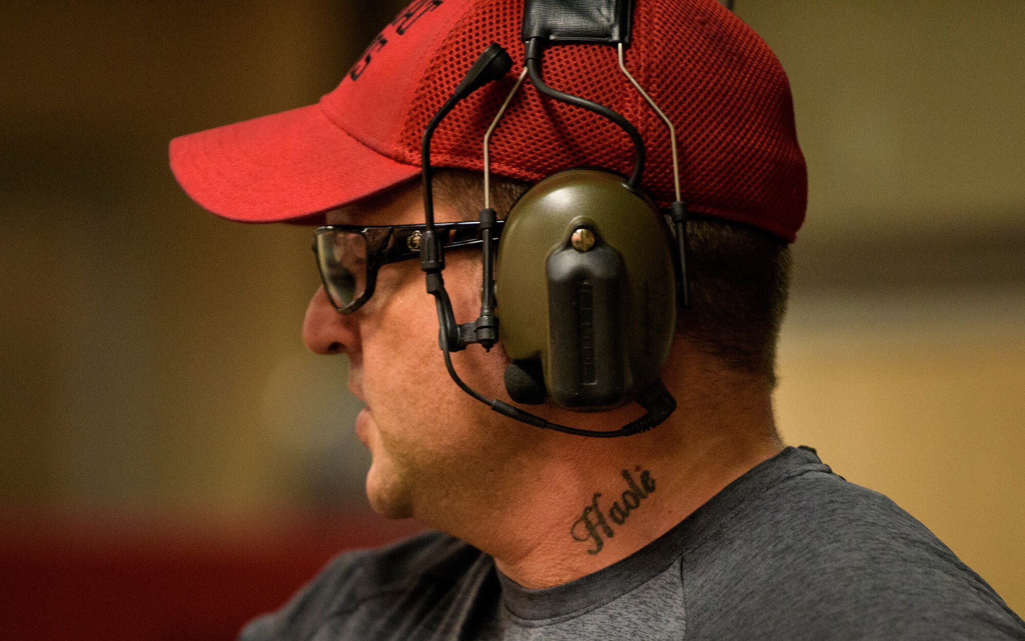 Officer Tim Bull, a Combat Arms Training and Maintenance instructor, looks out over the firing range, April 25, 2018. Bull has a tattoo on his neck with the word "haole". The word has two meanings according to Bull, meaning both "breath" and being an outsider to Hawaiian culture. Bull also served in the United States Army as an infantryman and was stationed in Hawaii where he met his wife who was a Hawaii native. (U.S. Air Force photo by Airman 1st Class Dalton Williams)