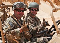 Chief Master Sgt. James Loper, 10th Air Force Command Chief, joins in a thumbs-up as he prepares to test-drive an MRZR military all terrain vehicle