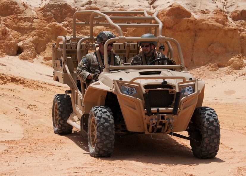 Chief Master Sgt. James Loper, 10th Air Force Command Chief, rides aboard an MRZR military all terrain vehicle with Chief Master Sgt. Brian Bischoff