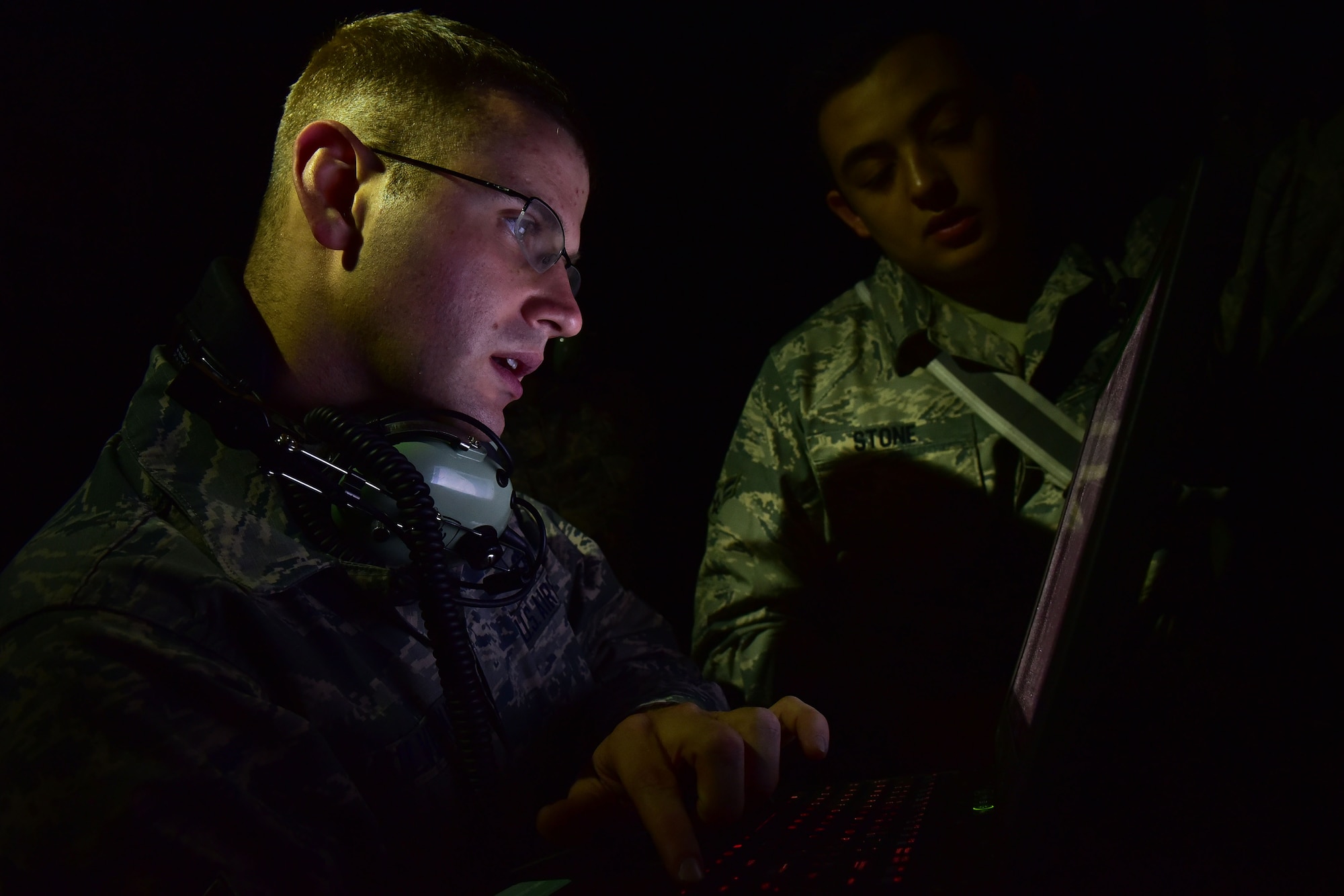 A man looks at an open laptop.