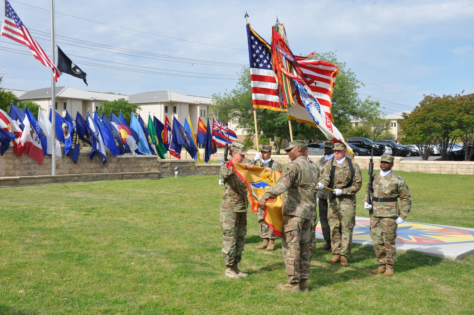 Col. Lynda Armer (left) and Command Sgt. Maj. Darnyell Parker uncase the 418th Contracting Support Brigade colors during a ceremony April 20 at Fort Hood, Texas. The uncasing of organizational colors signals the return from deployment to Afghanistan for the unit. Armer is the 418th CSB commander and Parker is the brigade command sergeant major.