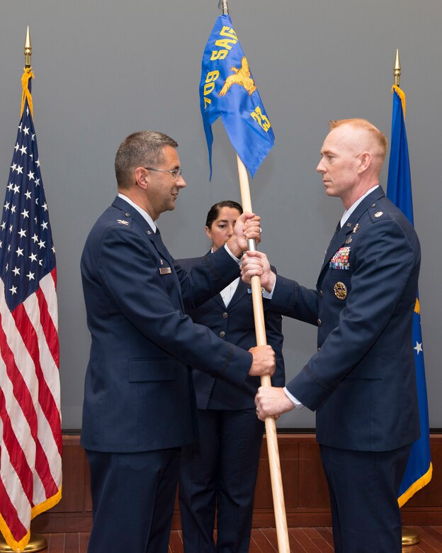 Lt. Col. Jeremy Goodwin (right), 23rd Analysis Squadron commander, accepts his unit’s guidon from Col. Jonathan VanNoord, 709th Surveillance and Analysis Group commander during a ceremony in the Doyle M. Northrup Auditorium at the Air Force Technical Applications Center, Patrick AFB, Fla., April 4, 2018.  Goodwin assumed command of the newly formed squadron after the nuclear treaty monitoring center reorganized to improve mission effectiveness.  (U.S. Air Force photo by Matthew S. Jurgens)