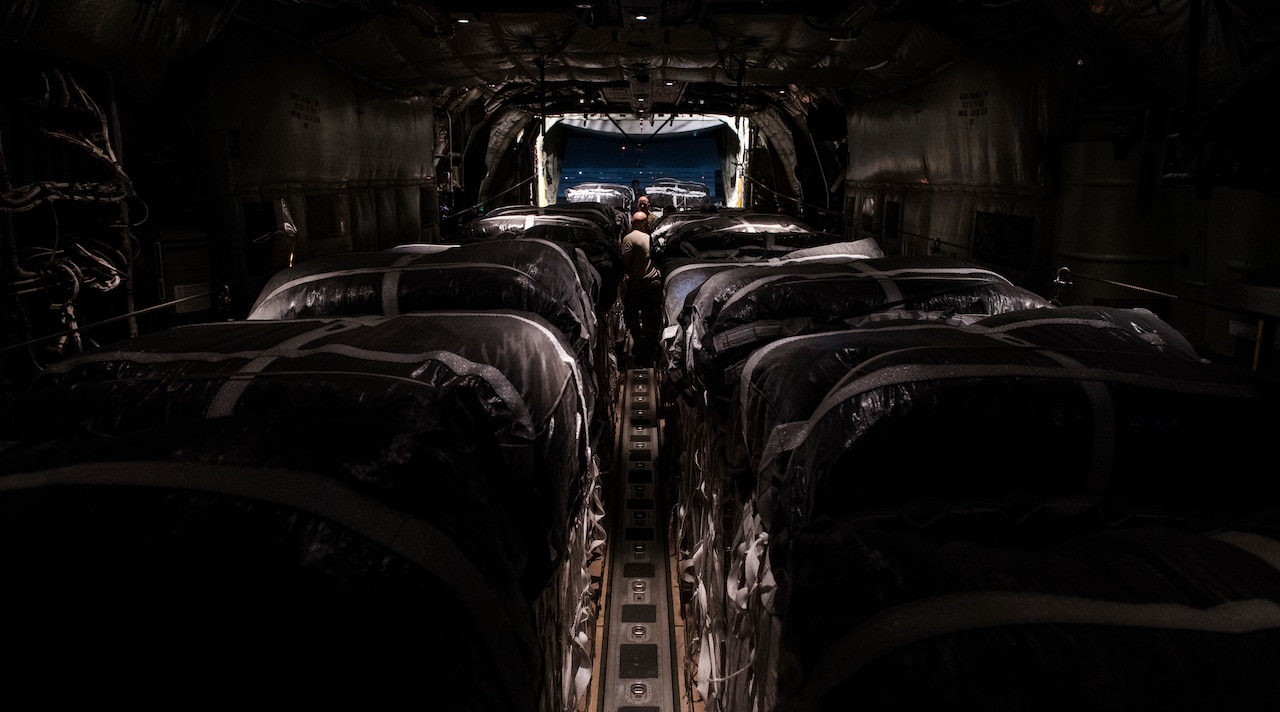 Airmen assigned to the 746th Expeditionary Airlift Squadron check bundles of cargo aboard a C-130J Super Hercules at Bagram Air Field.