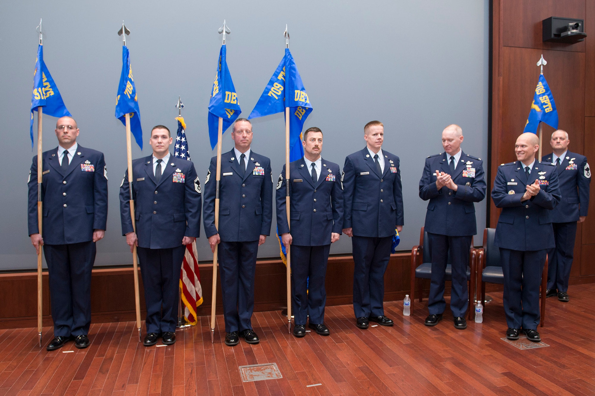 Members of the Air Force Technical Applications Center display newly unfurled detachment guidon flags during a ceremony in AFTAC’s Doyle M. Northrup Auditorium April 9, 2018, Patrick AFB, Fla.  Pictured left to right:   Senior Master Sgt. John M. Williams, Detachment 319, Germany; Senior Master Sgt. Jason L. Hutchinson, Detachment 402, Japan; Master Sgt. Jason C. Ellwinger, Detachment 421, Australia; Senior Master Sgt. Matthew D. Mohler, Detachment 460, Alaska; Master Sgt. Jesse L. Marsh, Detachment 403, Korea; Col. Richard Mendez, 709th Support Group commander; Lt. Col. Paul Hendrickson, 709th Technical Maintenance Squadron commander; and Chief Master Sgt. Chad Madore, 709th TMXS superintendent.  (U.S. Air Force photo by Matthew S. Jurgens)