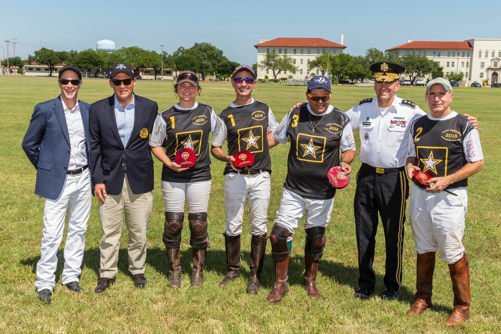 Lt. Gen Jeffrey S. Buchanan (right) , U.S. Army North (Fifth Army) commander, takes a group photo with the winners of the polo match during the annual Military Appreciation Weekend May 6, 2017 at Joint Base San Antonio-Fort Sam Houston, Texas. U.S. Army North and JBSA hosted the two-day event, which featured music, family activities, and various military demonstrations. This year, the appreciation weekend also commemorated the 300th anniversary for the city of San Antonio. (U.S. Air Force photo by Ismael Ortega / Released)