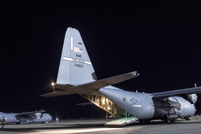 Two C-130J Super Hercules sit on the runway.