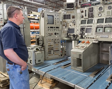 Rich Emerson, information security officer for Puget Sound Naval Shipyard & Intermediate Maintenance Facility, looks at the reassembled NR-1 control room after the official transfer of ownership ceremony May 8, 2018, at the U.S. Naval Undersea Museum, in Keyport, Washington. Emerson served aboard NR-1 from 2000 to 2003, when he was a nuclear electrician's mate chief. (Photo by Carie Hagins, PSNS & IMF photographer)