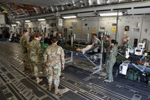 Maj. Rachel Blanset, 446th Aeromedical Evacuation Squadron, explains aeromedical evacuation procedures to graduating medical professionals from Madigan Army Medical Center on 24 April, 2018, at McChord Field, Wash. The three day capstone training event with the U.S. Army allowed for capabilities aboard a C-17 Globemaster III to be shown for patients being transported to a facility like Landstuhl Regional Medical Center in Germany.