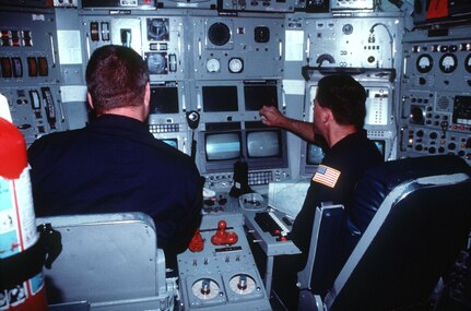 Machinist Mate First Class (MM1) Brett Jabia watches Lt. Cmdr. David Olivier, commanding officer of NR-1, the Navy's only nuclear-powered deep submergence research craft, adjust some instruments while cruising off the coast of Key Largo, Florida, May 19, 1995. (U.S. Navy photo by PH1 G. Hurd)