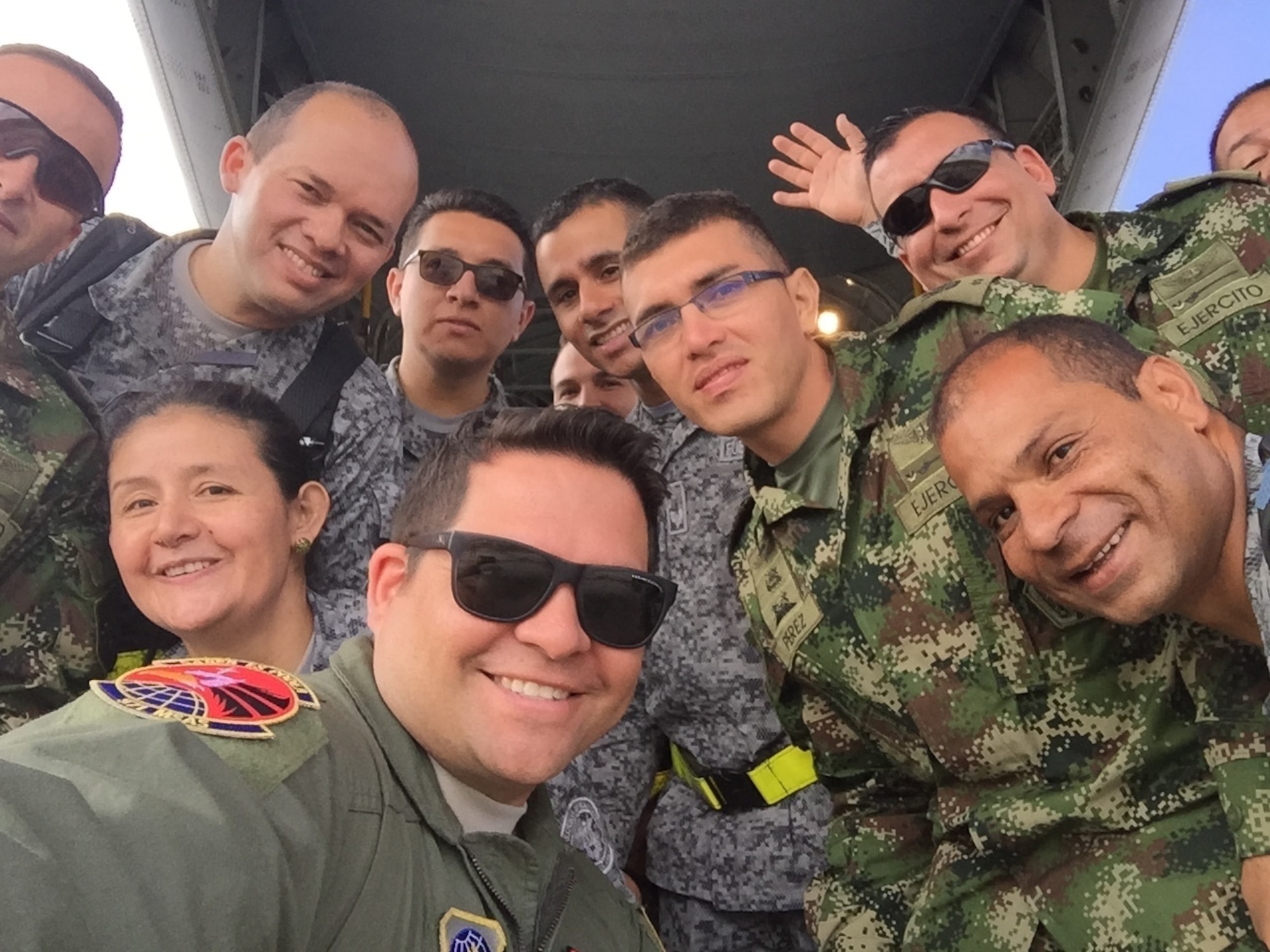 Lt. Col. Angel Santiago, 571st Mobility Support Advisory Squadron air advisor, poses for a photo with Colombian military members during a mobile team training mission in Bogota, Colombia, Feb. 17, 2017. During the MTT, the Colombian military received hands-on training on aircraft airdrop operations and aeromedical evacuation training. (Courtesy photo)