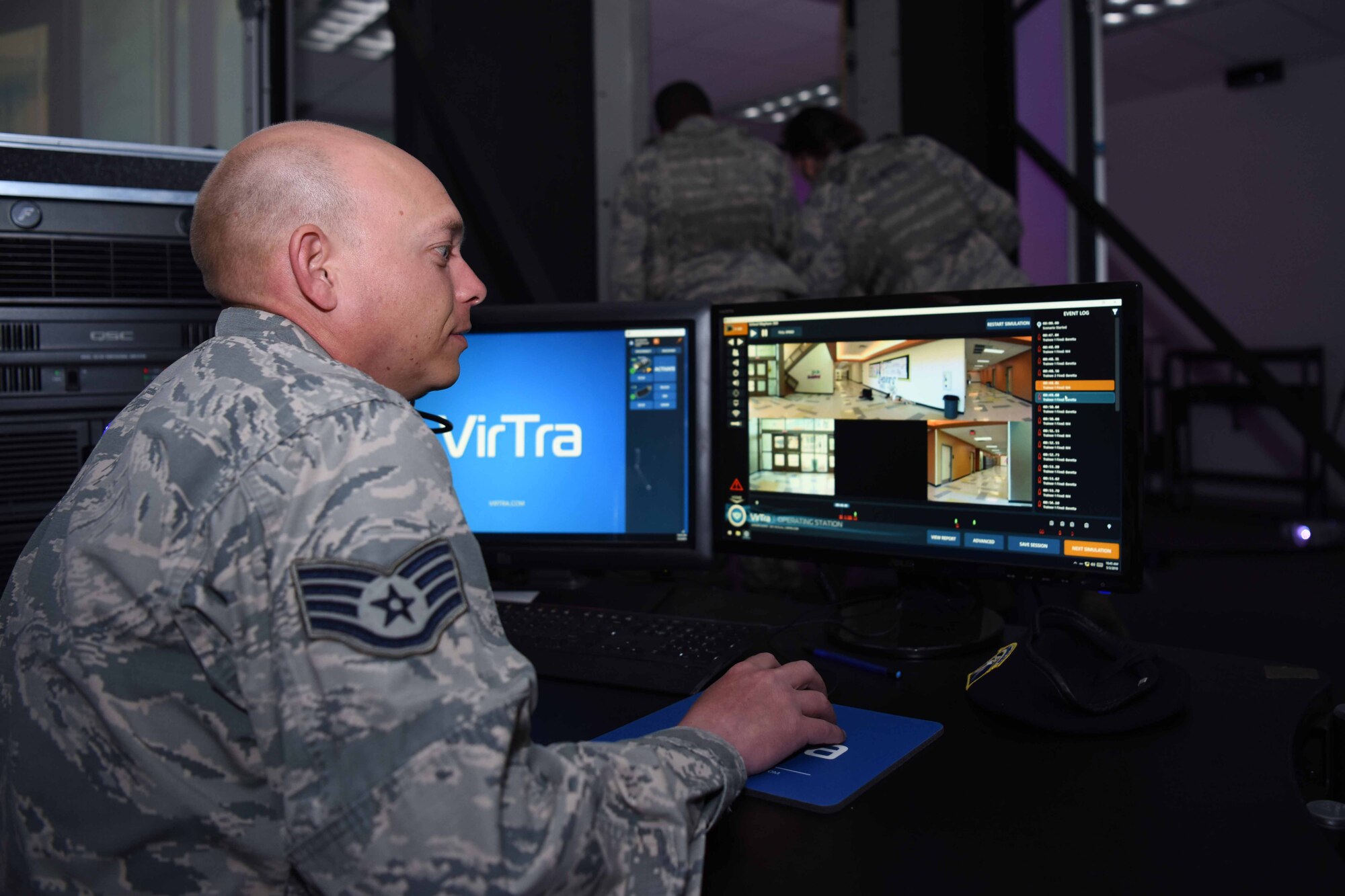 Staff Sgt. Terry Burk, 30th Security Forces Squadron unit trainer, manages the Virtual Reality Simulation while two defenders enter the simulator on May 3, 2018 at Vandenberg Air Force Base, Calif. Virtual Reality Simulation is a part of 30th SFS’s month of training and inside the simulation a team of two will be given scenarios and must react according to procedures. (U.S. Air Force photo by Airman Aubree Milks/Released)