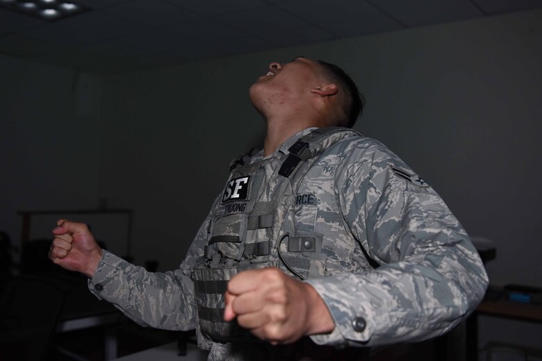 Airman 1st Class Brady Truong, 30th Security Forces Squadron apprentice, reacts to being stunned before entering the Virtual Reality Simulator on May 3, 2018 at Vandenberg Air Force Base, Calif. Members are stunned prior to entering the simulator to practice performing under stress. (U.S. Air Force photo by Airman Aubree Milks/Released)