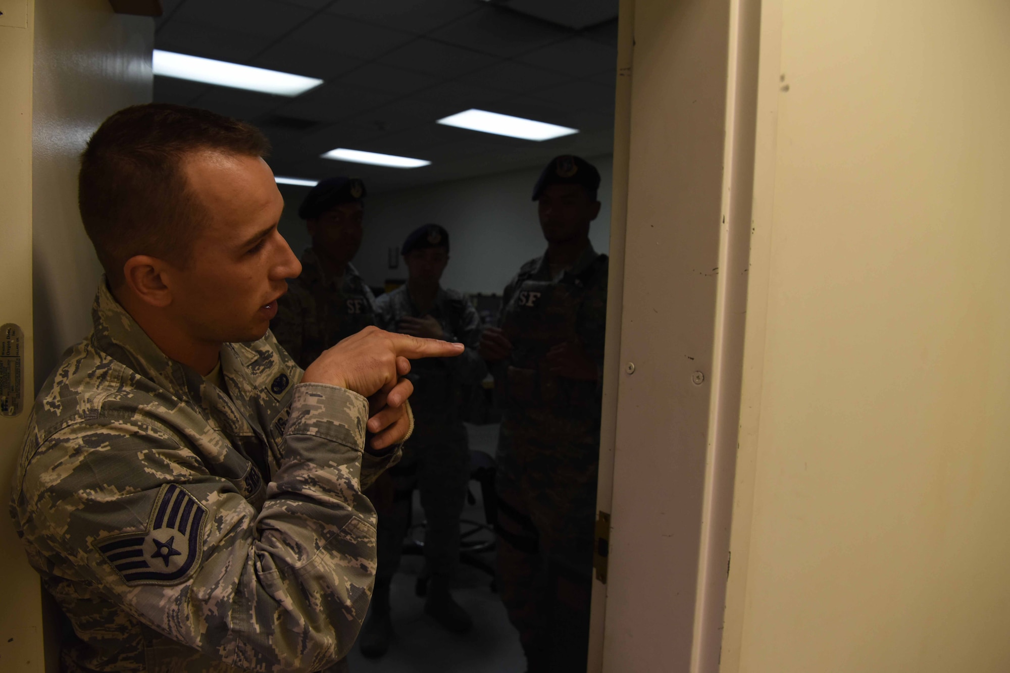 Staff Sgt. Kevin Swen, 30th Security Forces Squadron unit scheduler, demonstrates how to properly clear a building on May 3, 2018 at Vandenberg Air Force Base, Calif. Defenders spend one month every year training to improve their skills on the job. (U.S. Air Force photo by Airman Aubree Milks/Released)