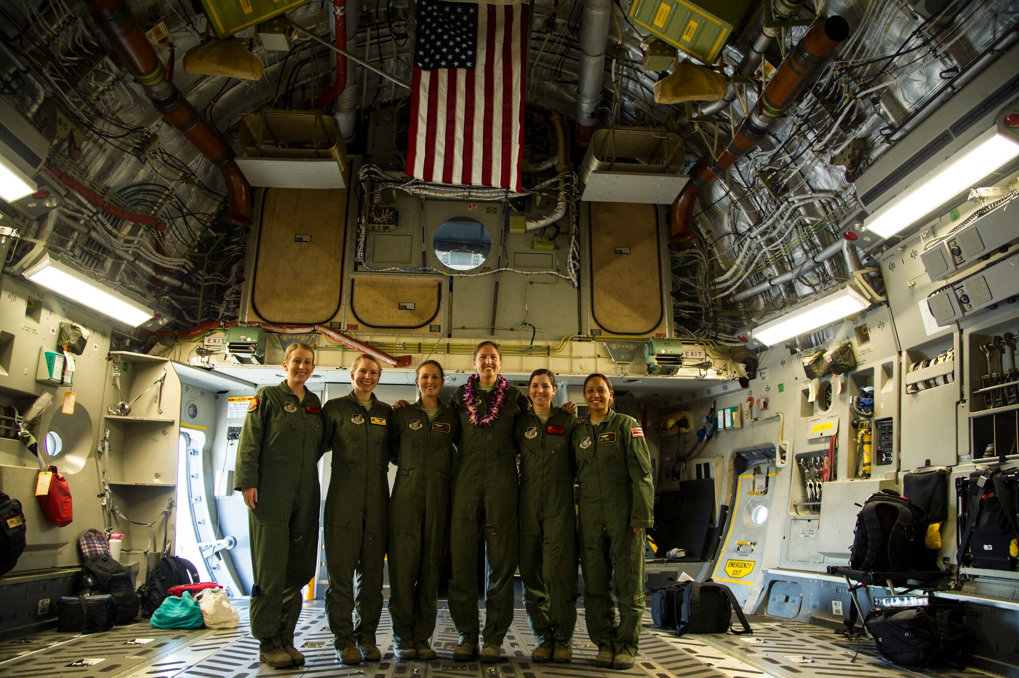 Maj. Jamilee Gunnels, Maj. Sean Perry, Maj. Brandee Taylor, Maj. Toni Merhar, Capt. Candi Piha, 535th Airlift Squadron C-17 Globemaster III pilots, and Tech. Sgt. Joleen Morse, 204th Airlift Squadron loadmaster, pose for a photo after an in-flight refueling mission, Joint Base Pearl Harbor-Hickam, Hawaii, April 25, 2018. The aircrew featured mothers to celebrate mothers who serve in the military and to highlight challenges Airmen face when balancing families and career. (U.S. Air Force photo by Tech. Sgt. Heather Redman)