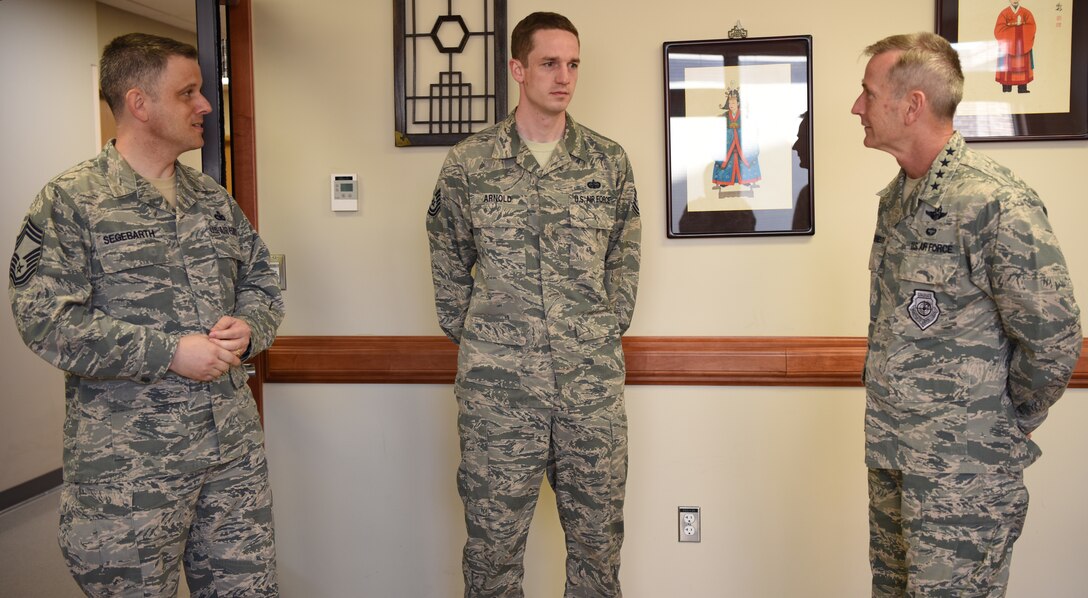 U.S. Air Force Gen. Terrence J. O'Shaughnessy, Pacific Air Forces commander, recognizes U.S. Air Force Tech. Sgt. Ryan Arnold, 51st Communications Squadron project manager, at Osan Air Base, Republic of Korea, May 9, 2018. Arnold led three Airmen to successfully close 10 network upgrade projects valued over $19 million, and his efforts directly contributed to the unit receiving 7th Air Force’s 2016 and 2017 Best Large Communications Squadron Awards. (U.S. Air Force photo by Airman 1st Class Ilyana A. Escalona)