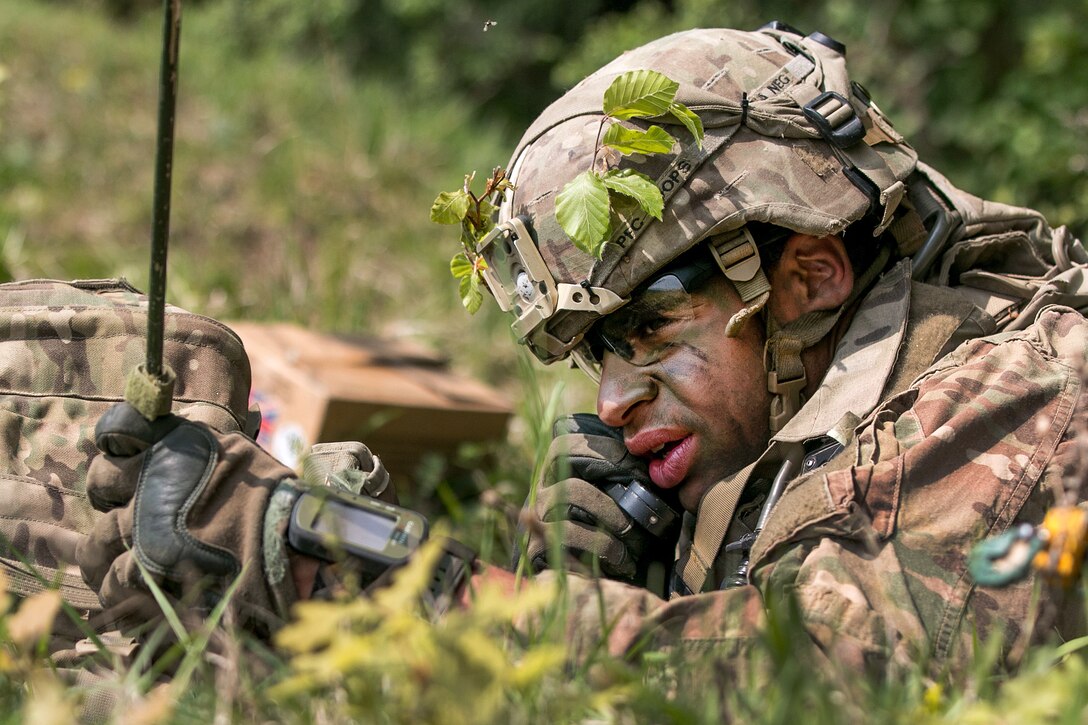 A soldier calls his headquarters to report simulated enemy activity.