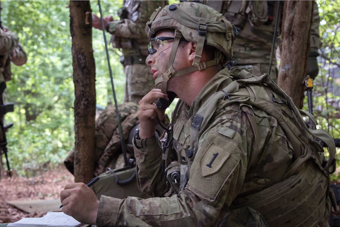 A soldier talks on a radio while Georgian soldiers coordinate fire missions.