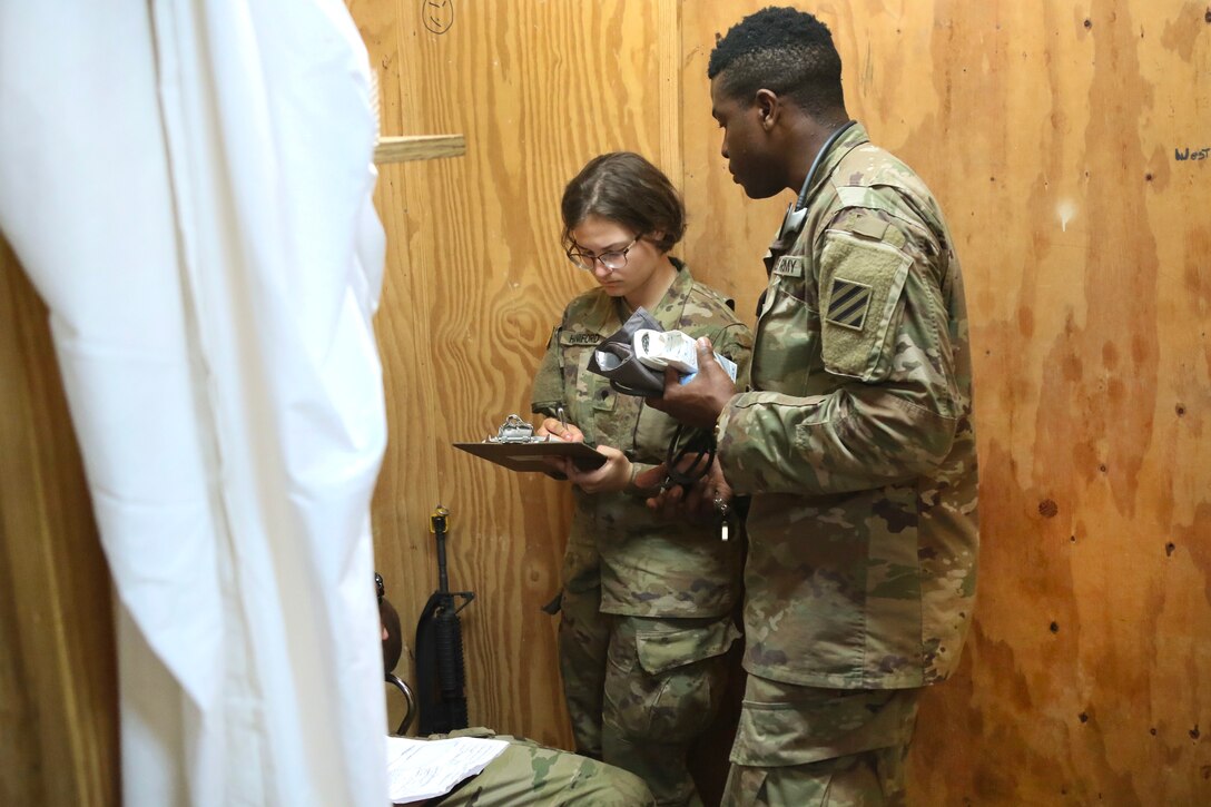 Soldiers conduct a patient assessment.