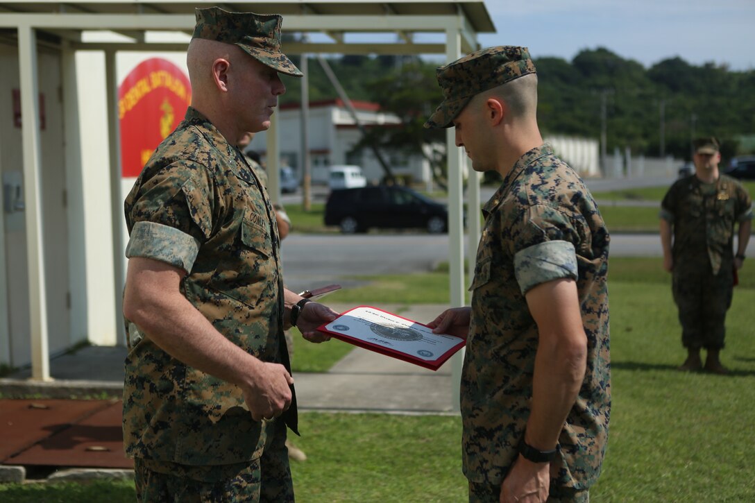 Brig. Gen. Daniel B. Conley, left, commanding general of 3rd Marine Logistics Group, awards Lt. Nicholas Crossland, a dental officer with Combat Logistics Battalion 31, 31st Marine Expeditionary Unit, with the Lt. J.G. Weedon E. Osbourne Memorial Award May 5, 2018 on Camp Foster. Crossland was awarded this for his work while attached to the 31st MEU. The Osborne award is given to dental officers who exhibit superior leadership while serving with the field medical service. (U.S. Marine Corps photo by Lance Cpl. Jamin M. Powell)