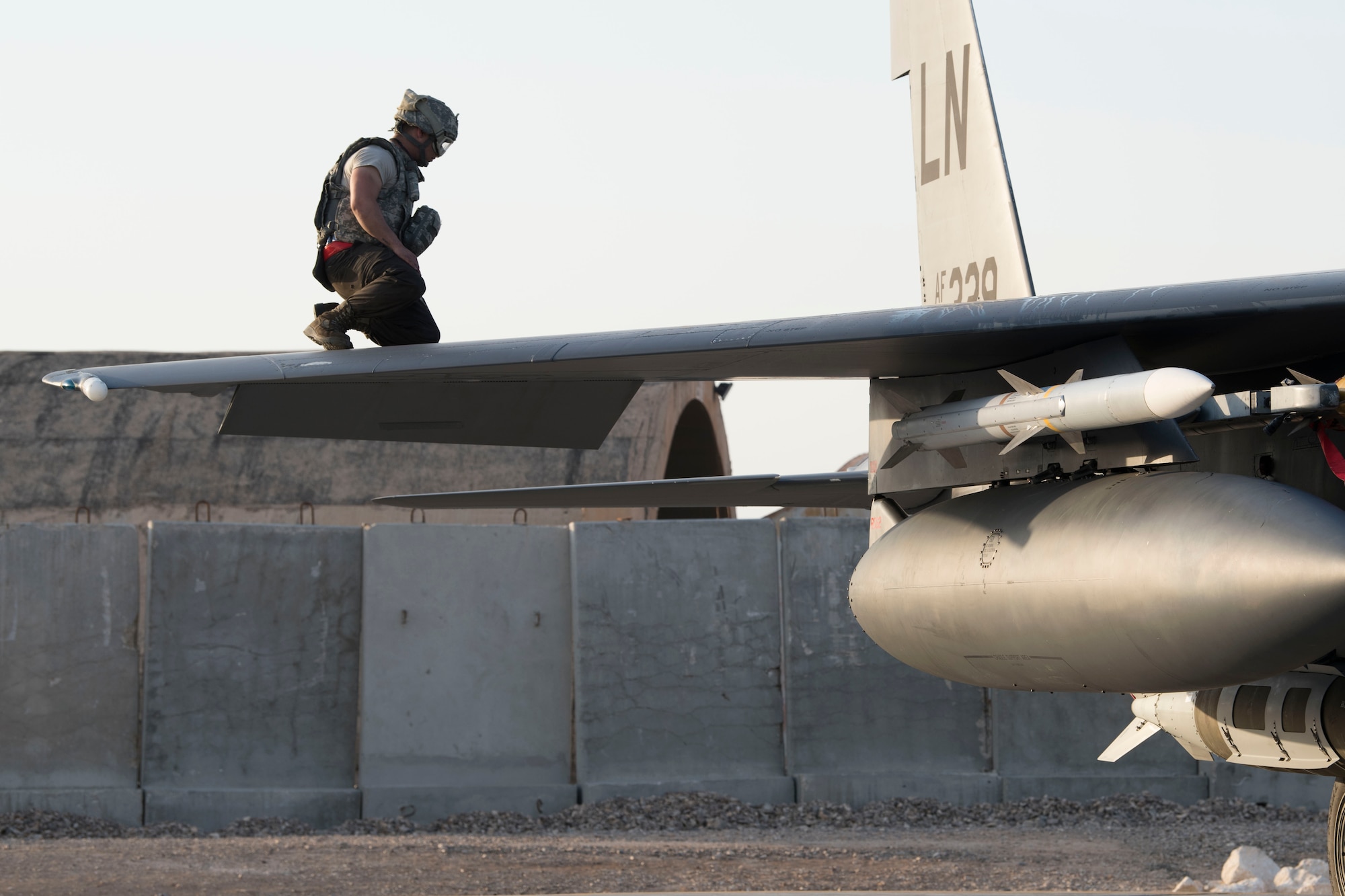 An Airman with the 332nd Expeditionary Maintenance Squadron examines the wings of an F-15E Strike Eagle April 8, 2018, at an undisclosed location in Southwest Asia.
