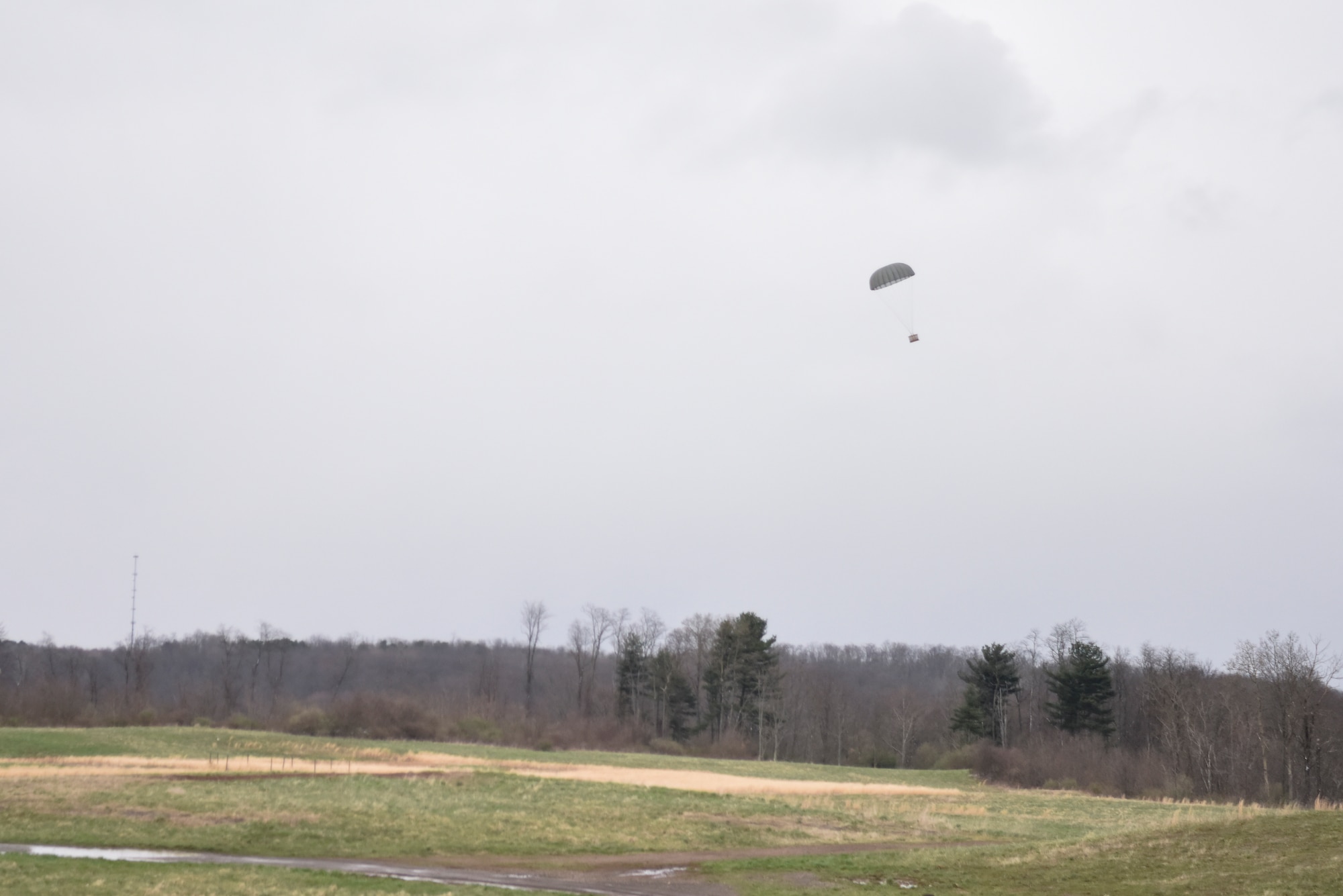 Cargo drops from a C-130 Hercules at the Starvaggi Drop Zone near Burgettstown, Pennsylvania, April 17, 2018. This was the last cargo drop performed by a C-130 assigned to the 911th Airlift Wing, marking the end of an era prior to their transition to the C-17 Globemaster III aircraft. (U.S. Air Force courtesy photo by Richard Oram)