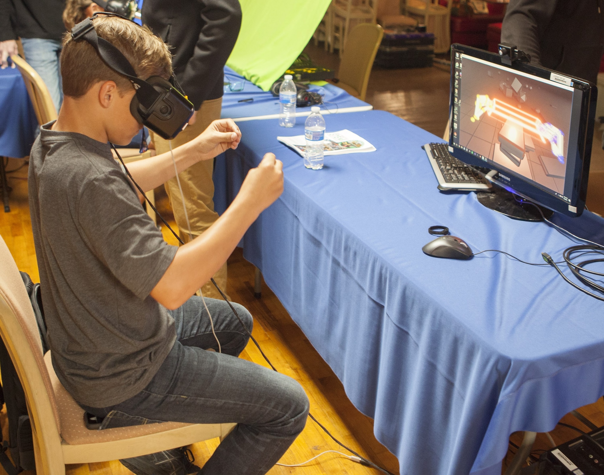 A participant explores virtual reality capabilities in gaming software during the sixth annual Full-Throttle STEM® at Eldora Day in Rossburg, Ohio, May 8. Students from seven local high schools showcased their STEM-related projects, including their modeling and simulation-based work, and then competed in a remote-controlled (RC) car race at Eldora Speedway. (U.S. Air Force photo/William Graver)