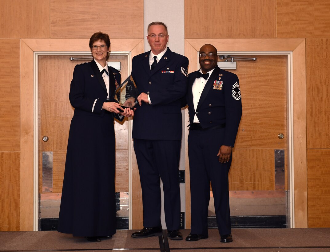 Tech. Sgt. Brian Diamond recieves the Medical Excellence Award at the 911th Airlift Wing's 2017 Annual award banquet Pittsburgh International Airport, Pennsylvania, May 5, 2018. Col. Karen Steiner, the commander of the 911th Aeromedical Staging Squadron, and Chief Master Sgt. Philip Gilbert, the 911th ASTS superintendent, presented Diamond with the award. Diamond is a health services management craftsman. (U.S. Air Force Photo by Staff Sgt. Zachary Vucic)