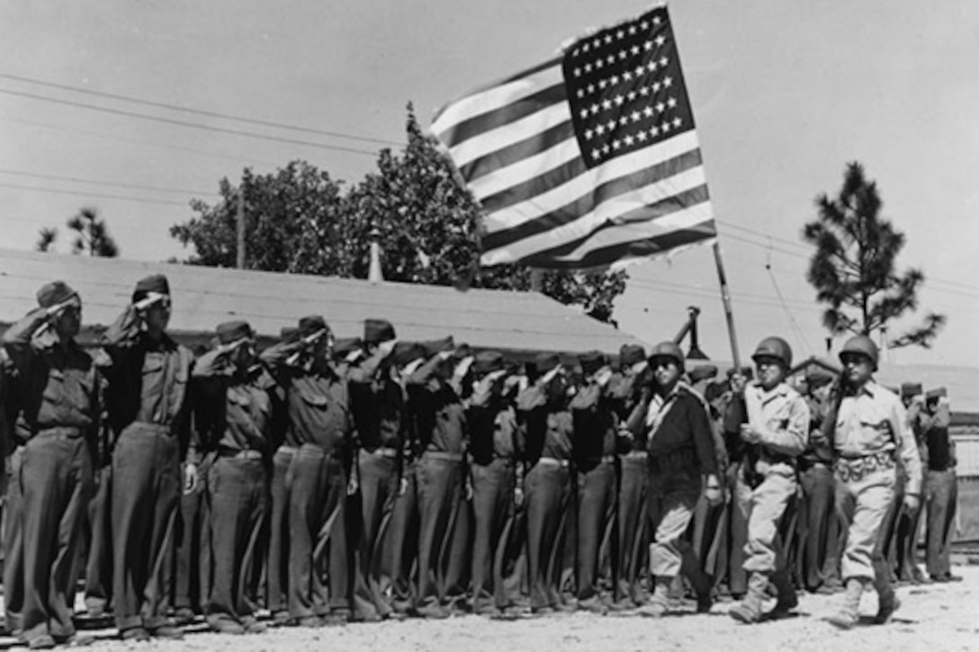 Members of the 442nd Regimental Combat Team salute the American flag.