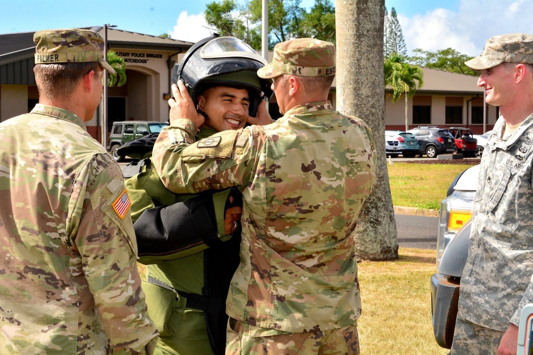 Army Command Sgt. Maj. Jacinto Garza dons a protective suit during a visit with explosive ordnance disposal technicians assigned to the 303rd Ordnance Battalion at Schofield Barracks, Hawaii, April 23, 2018. Garza is the senior enlisted advisor for the 8th Theater Sustainment Command at Fort Shafter, Hawaii, which oversees all sustainment support to Army units across the Pacific region. Army photo by Sgt. 1st Class John Brown