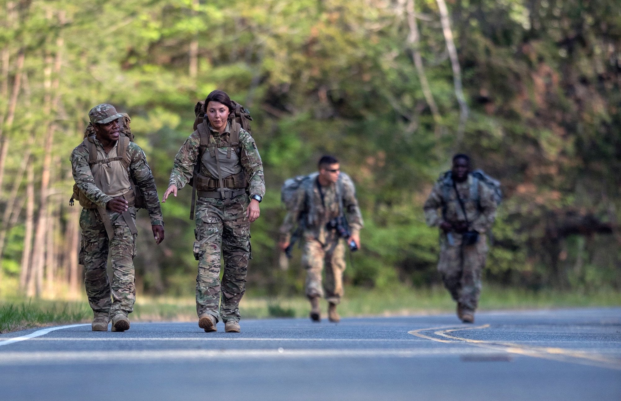 Airman 1st Class Franklin Harris (left) and Senior Airman Maygan Straight, both assigned to 1st Combat Camera Squadron, conduct the 10-mile road march part of the 2018 SPC Hilda I. Clayton Best Combat Camera Competition at Marine Corps Base Quantico, Va., May 3, 2018. The competition is an annual event open to all branches of the military, it's hosted by the 55th Signal Company (Combat Camera) in order to test the technical and tactical proficiencies of Defense Department combat photographers. (U.S. Army photo by Staff Sgt. Pablo N. Piedra)