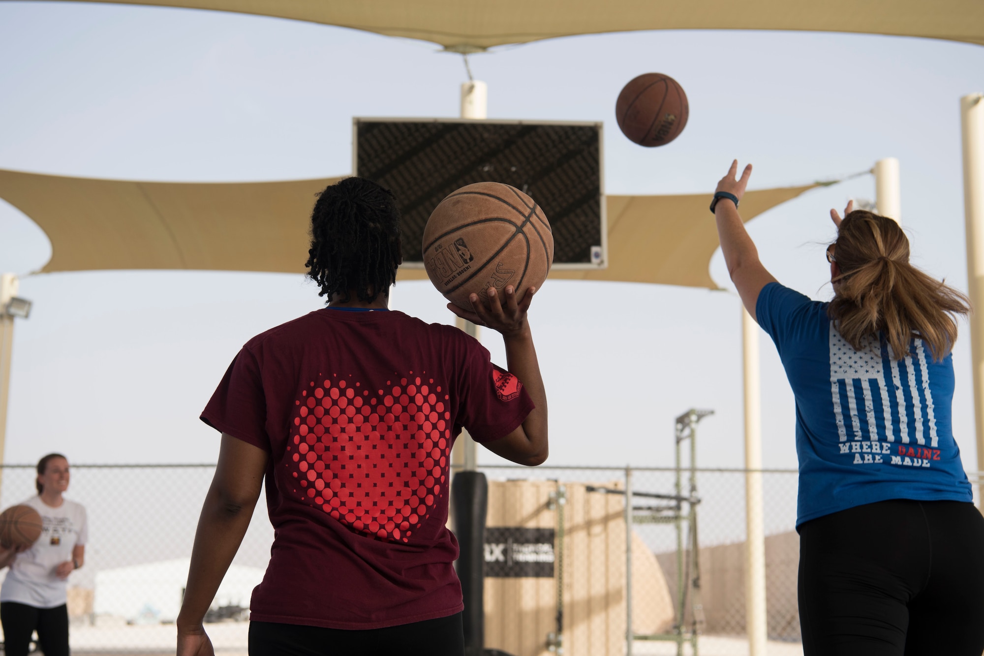 Airmen with the 332nd Air Expeditionary Wing attempt to throw a 3-pointer during the Commander’s Challenge at an undisclosed location in Southwest Asia May 4, 2018.