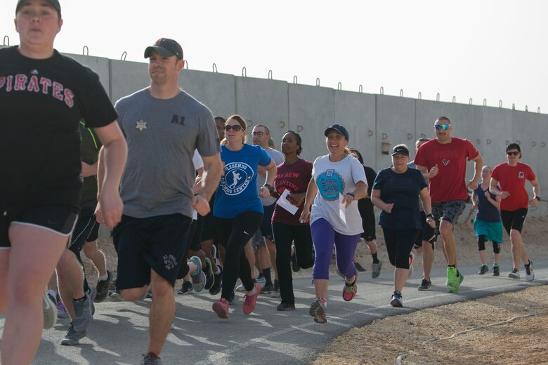 Airmen with the 332nd Air Expeditionary Wing run during the Commander’s Challenge at an undisclosed location in Southwest Asia May 4, 2018.